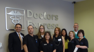 Darius Kerman, Doctors Express owner (far left) and Dr. Mark Siemer (far right) and their staff